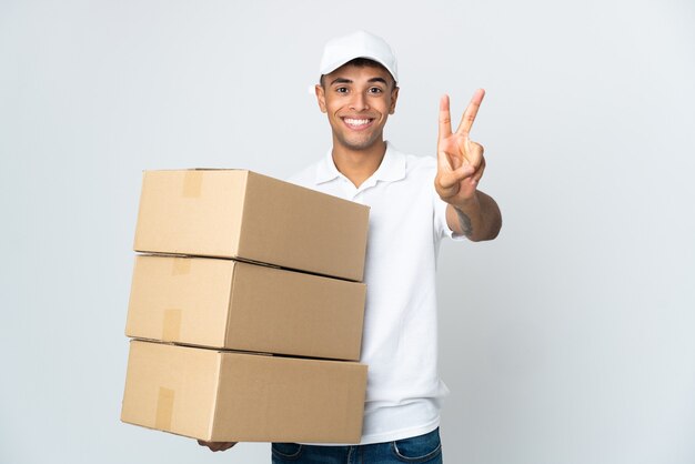 Delivery man posing isolated against the blank wall