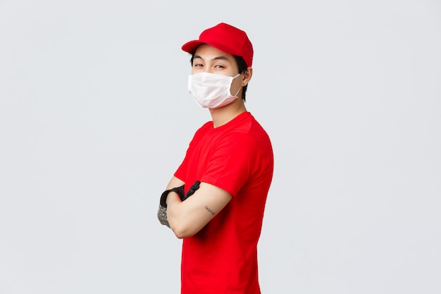 Delivery man in a red t-shirt wearing medical mask