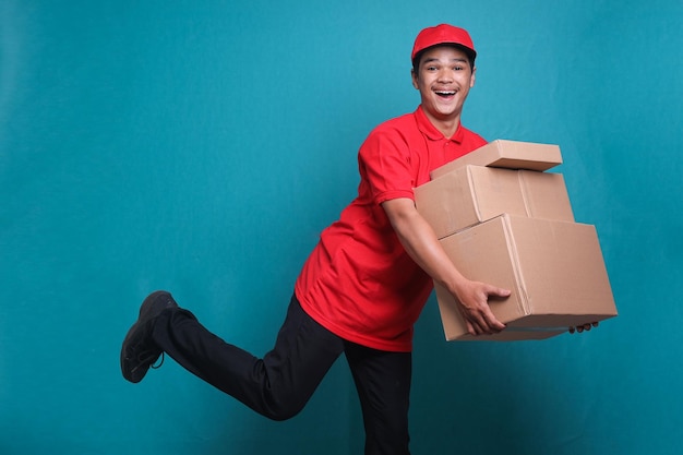 Delivery man in red uniform work as dealer courier hold a stack of blank cardboard box