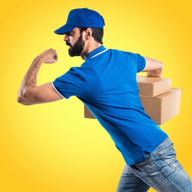 Delivery man running fast on colorful background