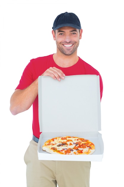 Delivery man showing fresh pizza on white background