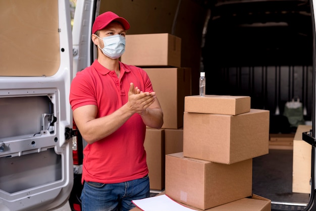 Photo delivery man using hand sanitizer