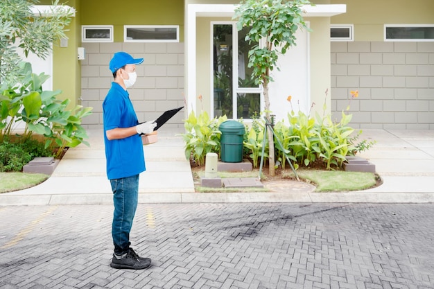 Delivery man wear mask while hold packages