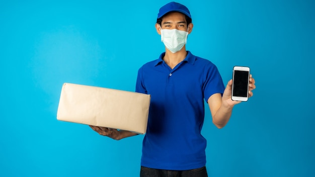 Delivery man wearing mask holding box