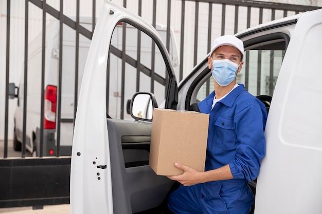 Delivery man wearing mask medium shot