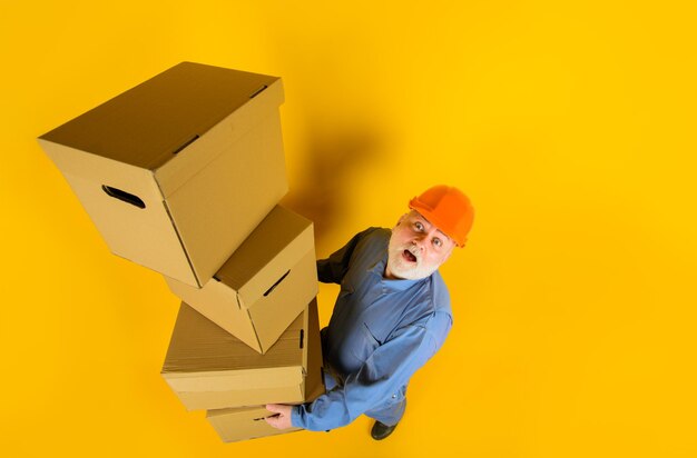 Delivery man with boxes man holds cardboard box bearded man carry boxes delivery from shop delivery