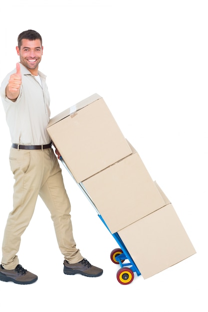 Photo delivery man with cardboard boxes gesturing thumbs up