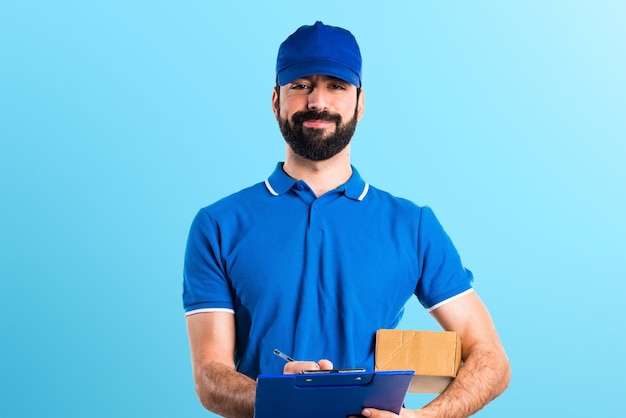 Delivery man with folder on colorful background