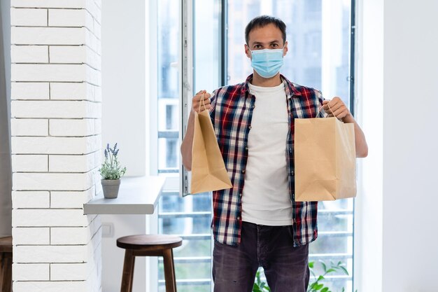 delivery man with paper containers for takeaway food.