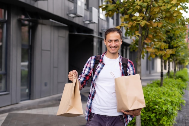 delivery man with paper containers for takeaway food.