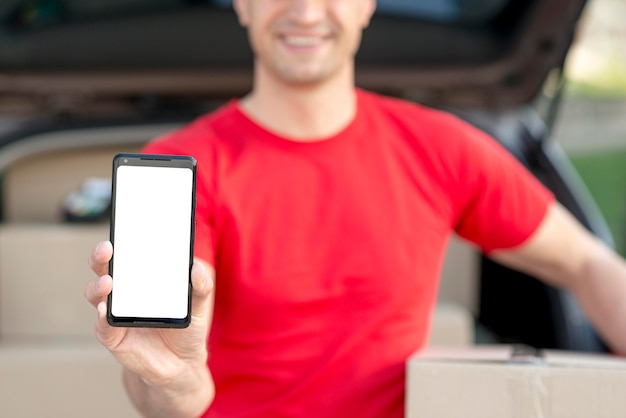 Delivery man with smartphone close-up