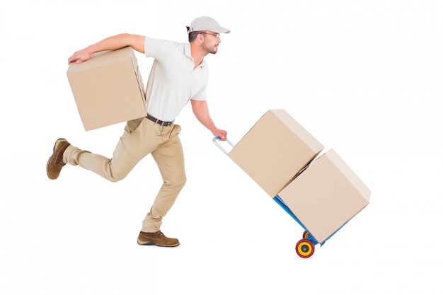 Photo delivery man with trolley of boxes running