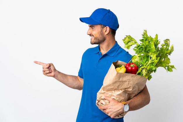 Delivery man with vegetables isolated