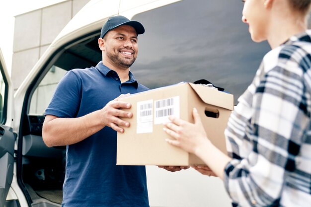 Delivery person giving boxes to woman