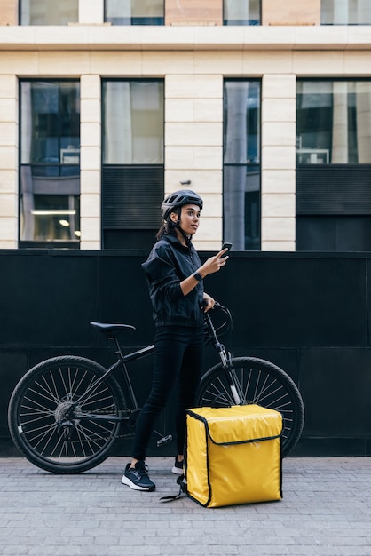 Photo delivery person using mobile phone by bicycle