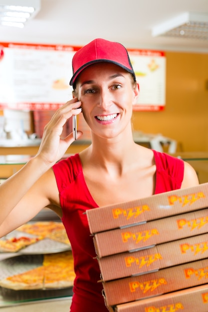 Delivery service, woman holding pizza boxes