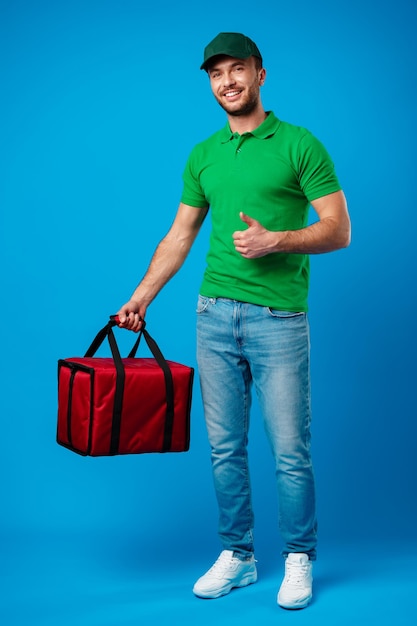 Delivery service worker with thermal bag against blue background