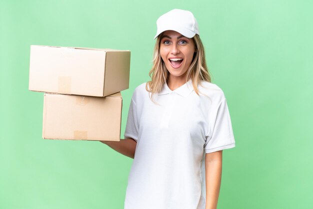 Delivery Uruguayan woman over isolated background with surprise facial expression