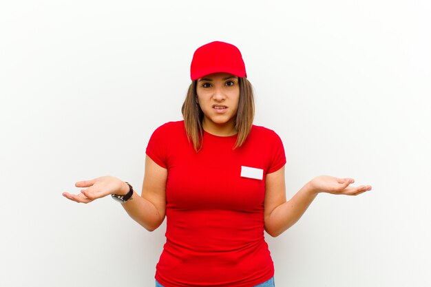 Delivery woman feeling clueless and confused, not sure which choice or option to pick, wondering against white 