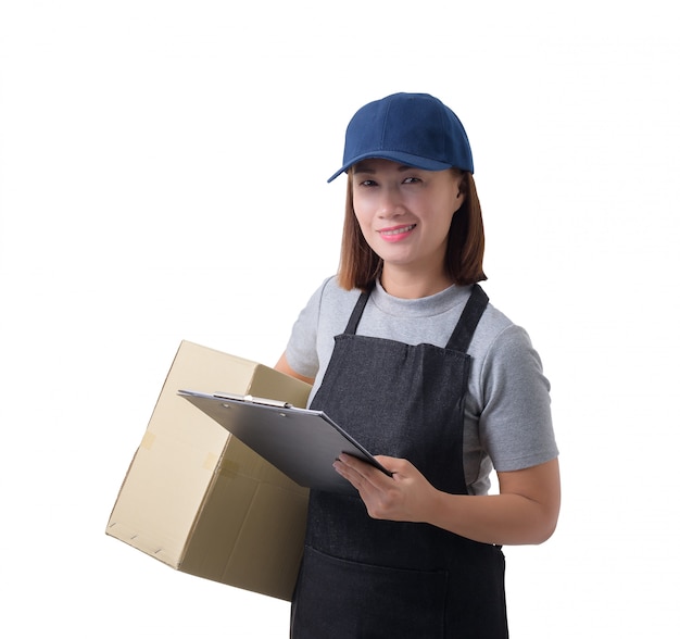 Delivery woman in Gray shirt and apron with stack of boxes is carrying parcel and presenting receiving form isolated 