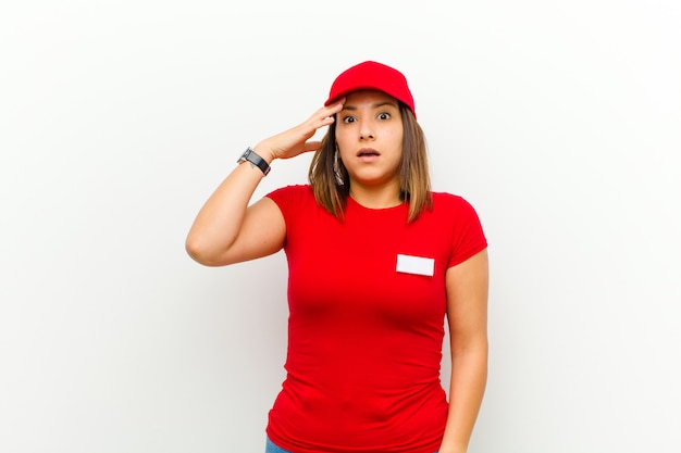 Delivery woman panicking over a forgotten deadline, feeling stressed, having to cover up a mess or mistake against white background