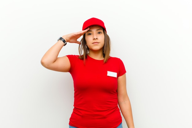 Delivery woman with a military salute in an act of honor and patriotism, showing respect