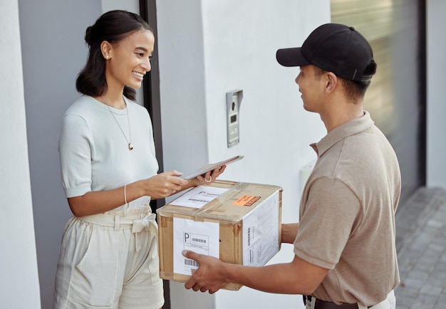 Delivery for you maam Shot of a young woman signing for an order with a delivery man using a digital tablet