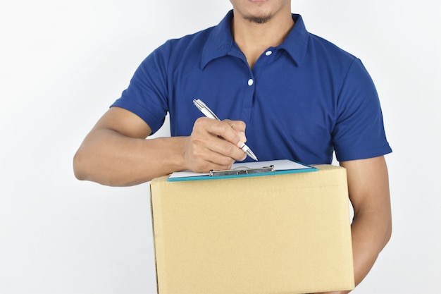 Delivery . young delivery holding box and writing something on clipboard.