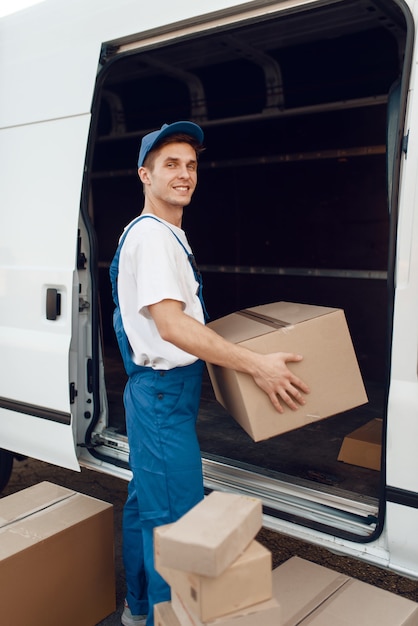 Deliveryman unloads the car with parcels, delivery