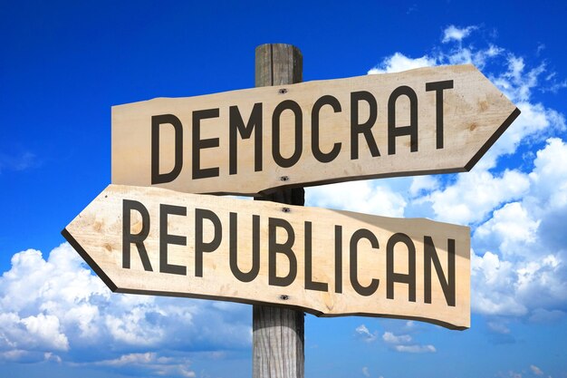 Democrat republican wooden signpost with two arrows sky with clouds in background