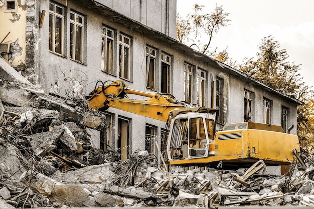 Demolition of a building with a hydraulic excavator