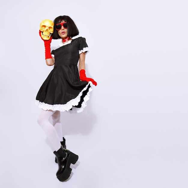 Demonic gothic stylish brunette Lady posing in white studio