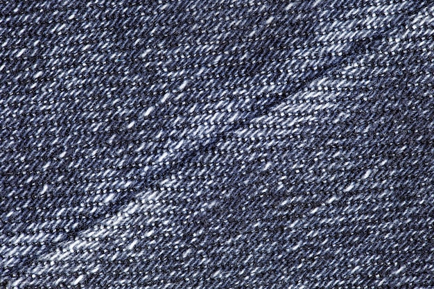 Denim blauwe close-up met naadverbinding op diagonaal uniforme textuur achtergrond