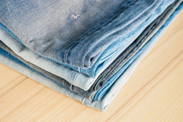 Denim blue jeans stack on table