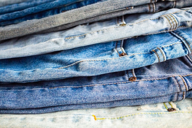 Premium Photo | Denim blue jeans stack texture background closeup