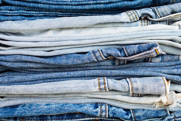 Denim blue jeans stack texture background closeup