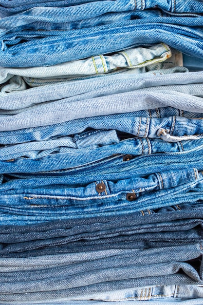 Denim blue jeans stack texture background closeup