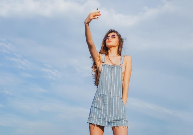 Denim girl woman in jeans dress beauty and fashion sexy girl woman in sunglasses with long hair