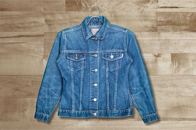 Denim jeans jacket on hanger isolated on white