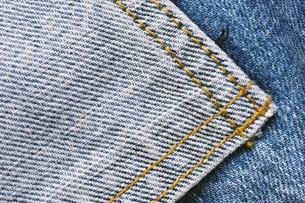 Denim jeans texture pattern Close up of pocket stitch fabric detail background