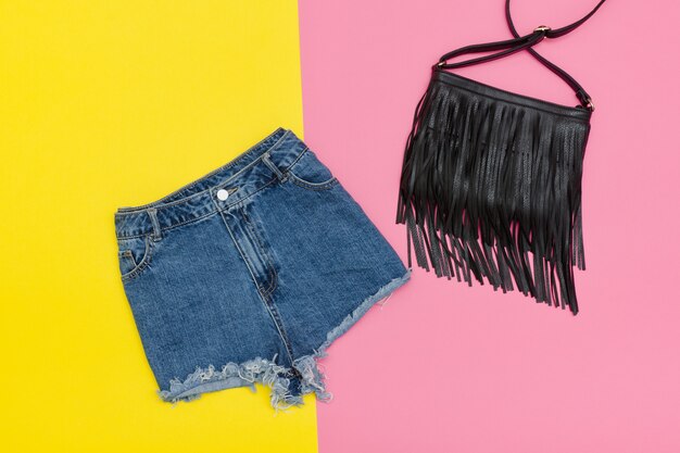 Denim shorts and black handbag.