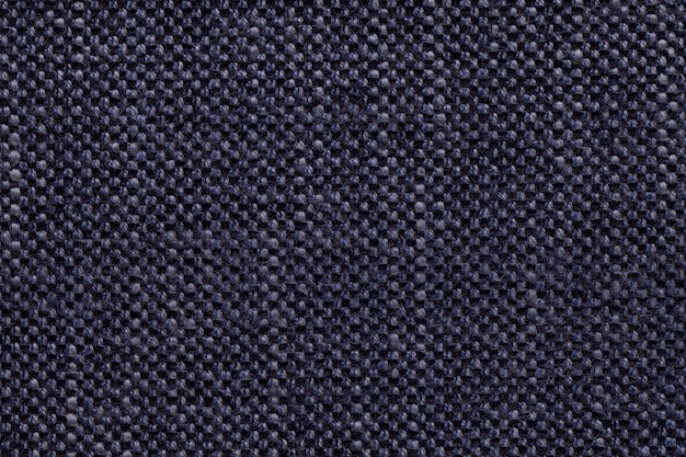 Denim textile background with checkered pattern, closeup. Structure of the fabric macro.