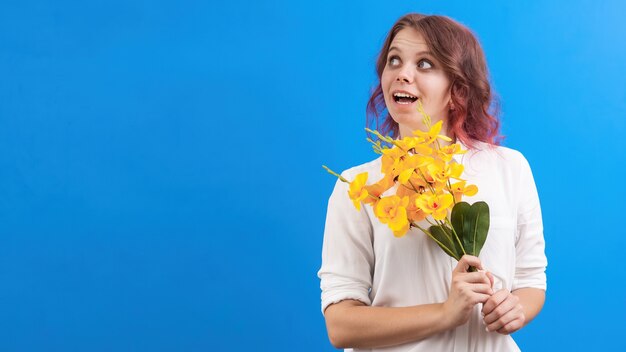 Denken lachende blanke vrouw met bloemen