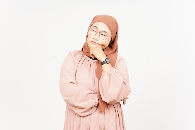 Denkend gebaar van mooie Aziatische vrouw die hijab draagt die op witte achtergrond wordt geïsoleerd