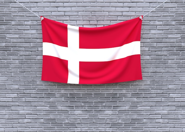 Denmark flag hanging on brick wall