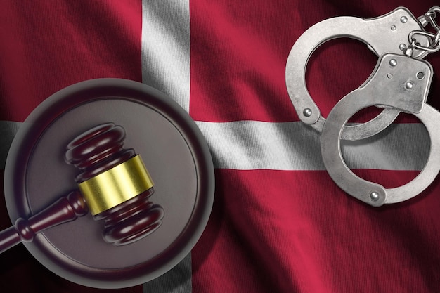 Photo denmark flag with judge mallet and handcuffs in dark room concept of criminal and punishment background for judgement topics