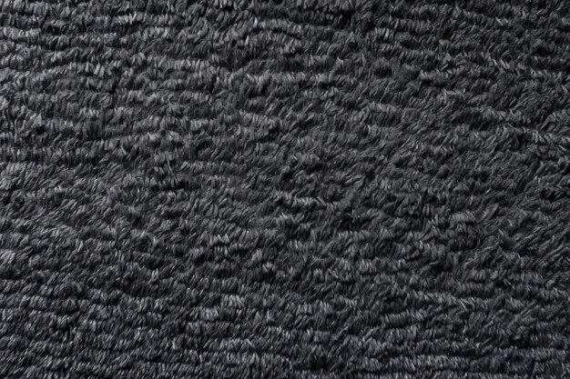Foto il tessuto sintetico nero denso diventa un tappeto grigio denso, quindi lo sfondo del tappeto grigio