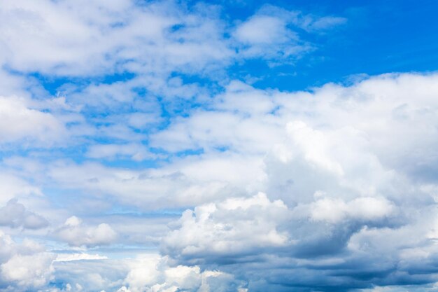 Dense white clouds in blue sky on summer day