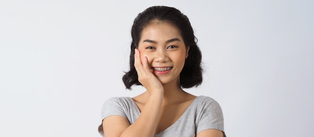 Dental brace beautiful girl smiling looking on a camera white teeth with blue braces Dental care