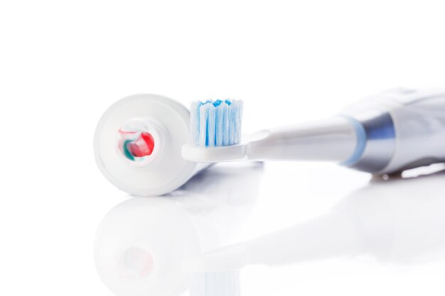 Dental brush and tube with paste isolated on white